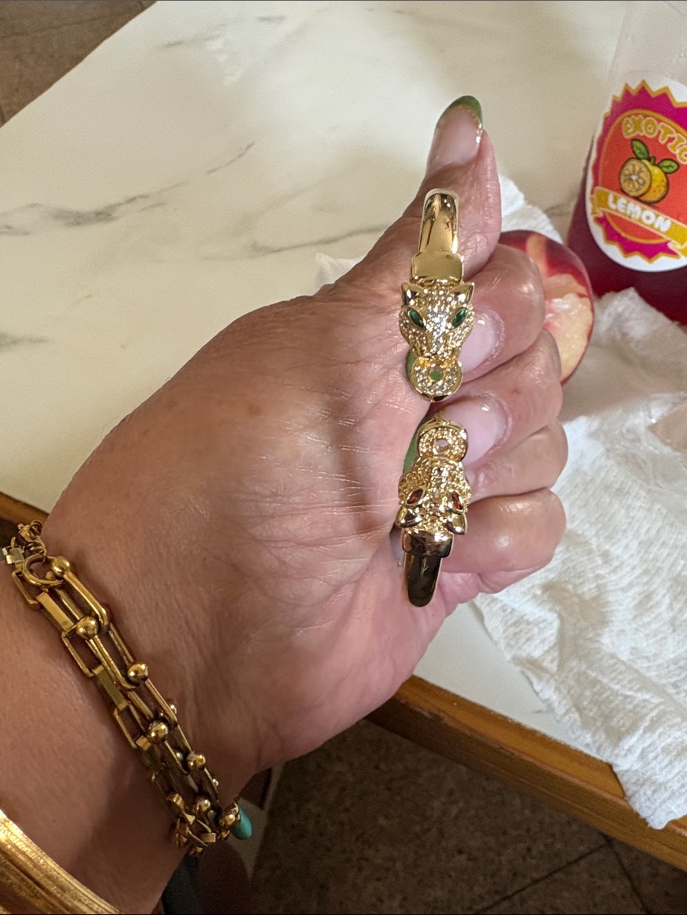 Gold-Tone Leopard Head Hinged Bangle Bracelet with Green and Red Crystal Accents